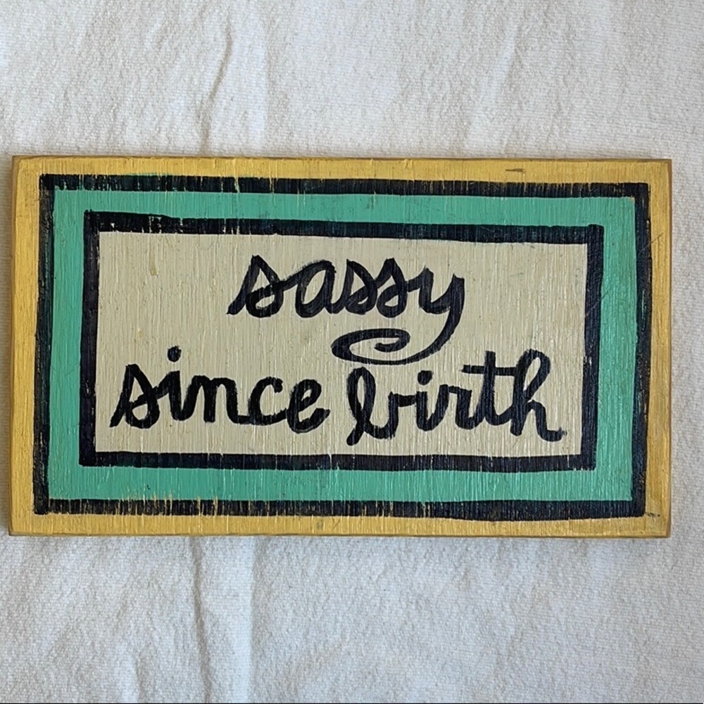 “Sassy since birth” wooden painted hanging sign.